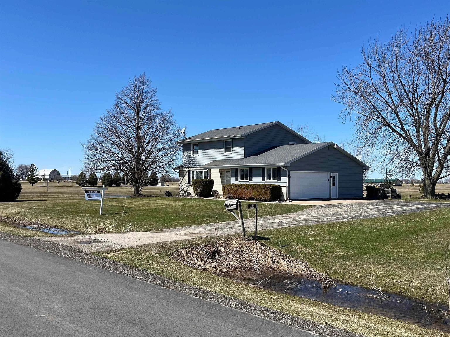 1690 West Ripple Avenue, Oshkosh WI — exterior view of the home and driveway from West Ripple Avenue